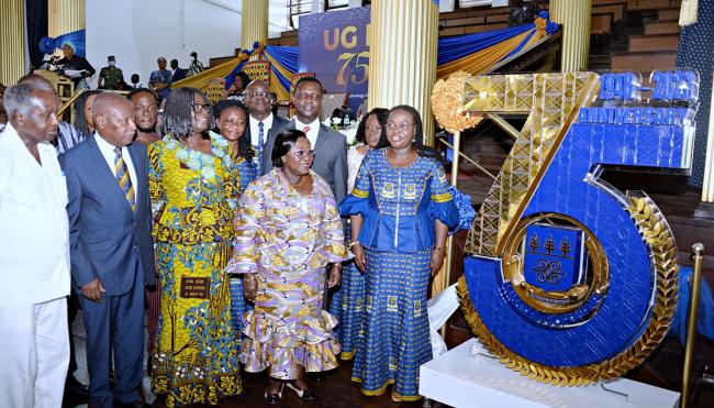 Image of Dignitaries having a view of the UG @ 75 logo